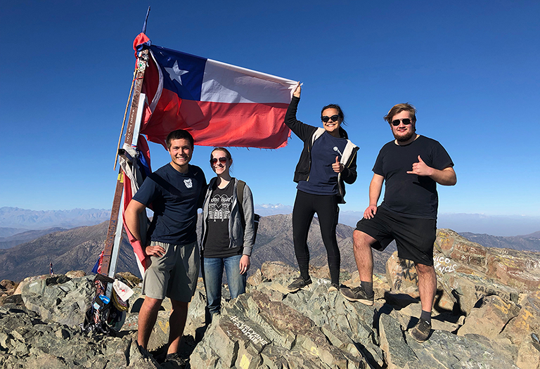 International students on top of a mountain