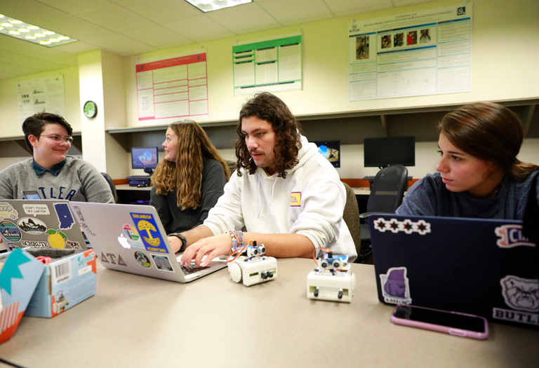 Students studying on computers together