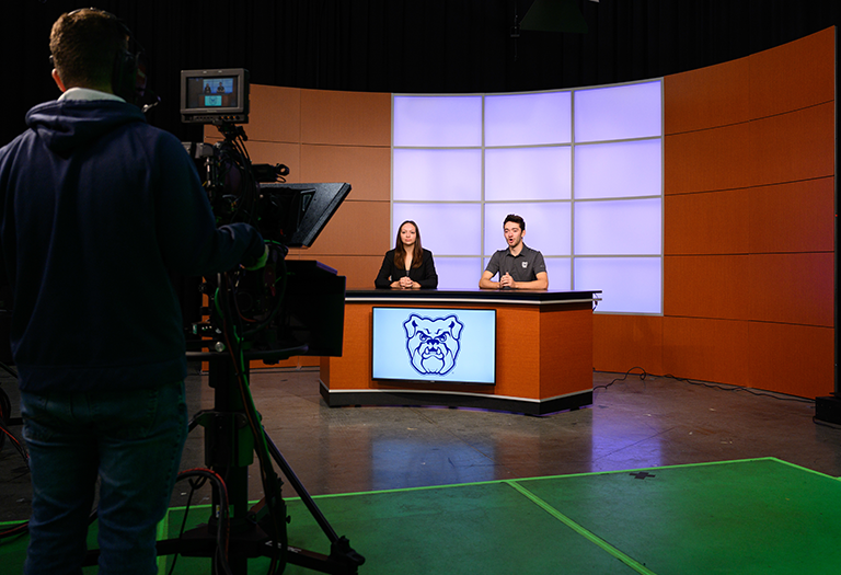 Photo of two students together reporting at Butler University
