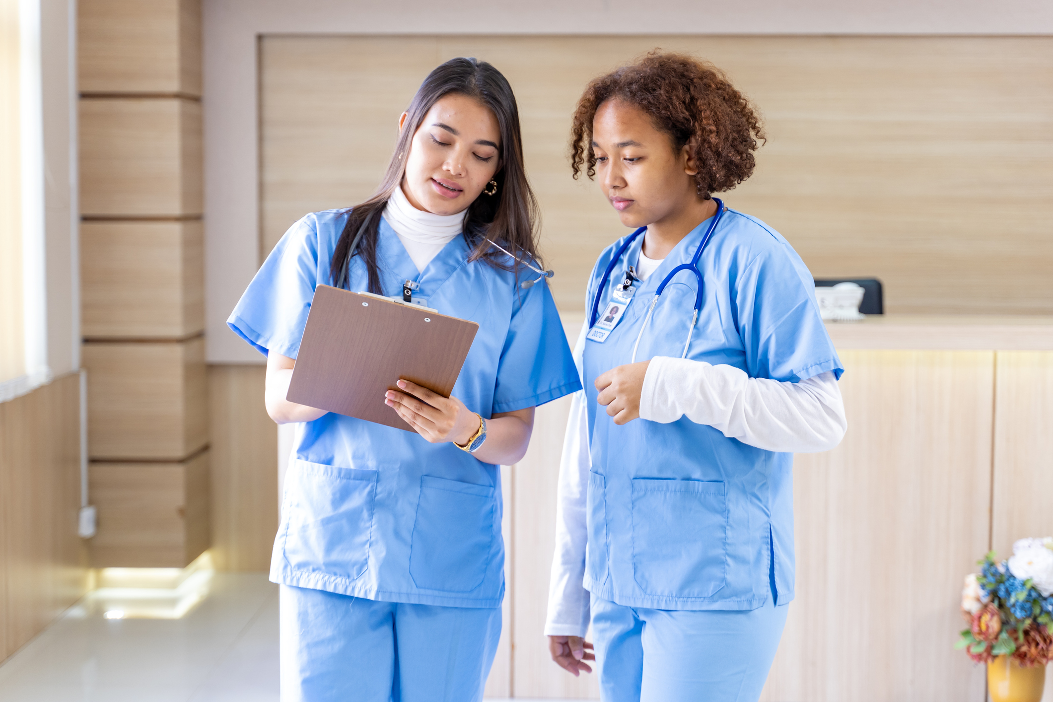 Team nurses is discussing and brainstorming on patient medical record after diagnosis for precise care plan with experienced physician specialist